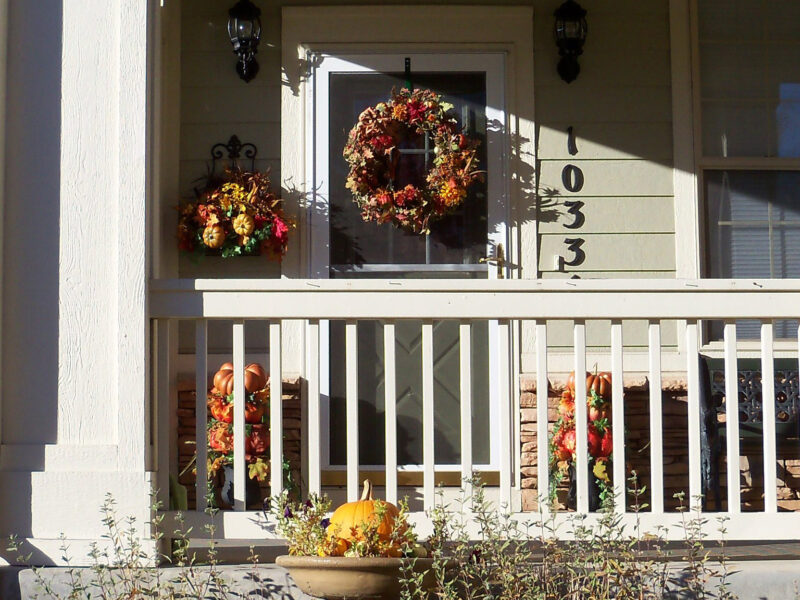 a decorated porch with a fall theme