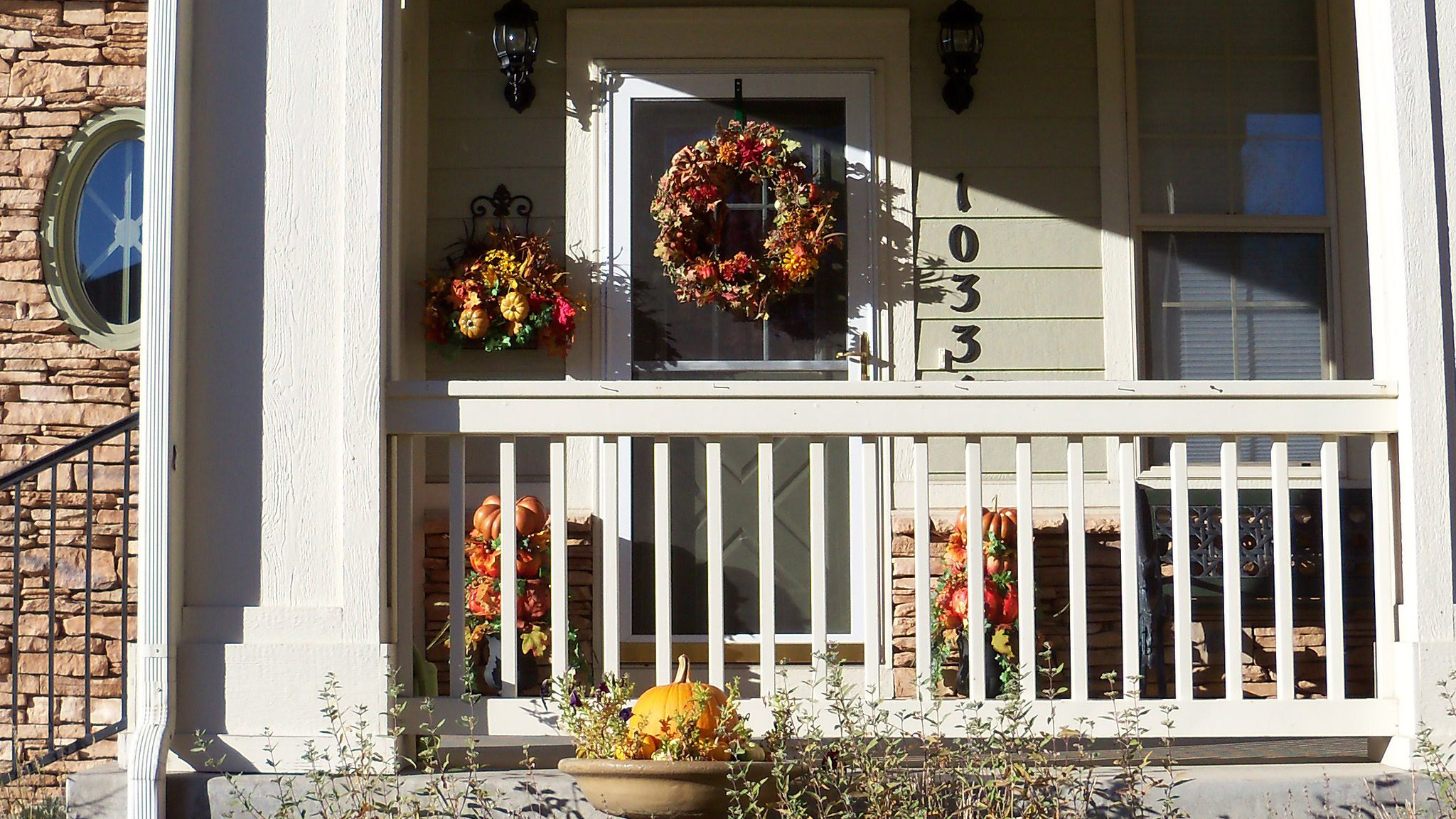 a decorated porch with a fall theme