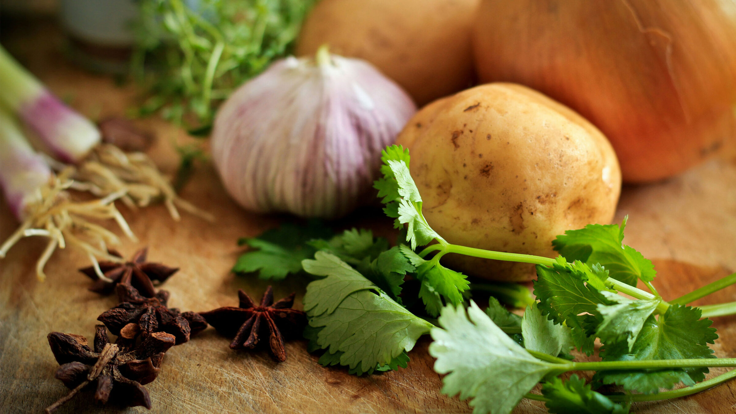 potato onion and parsley on a cutting board