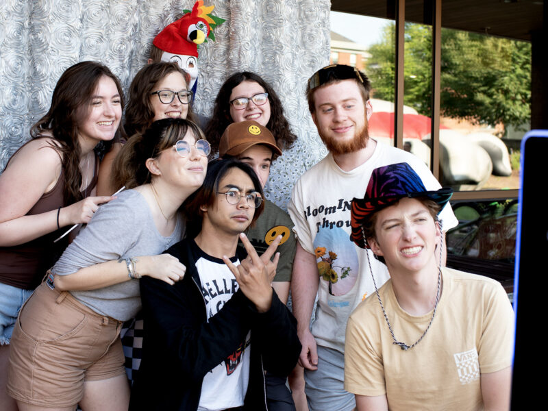 a group of student pose with pros and funny faces for a selfie