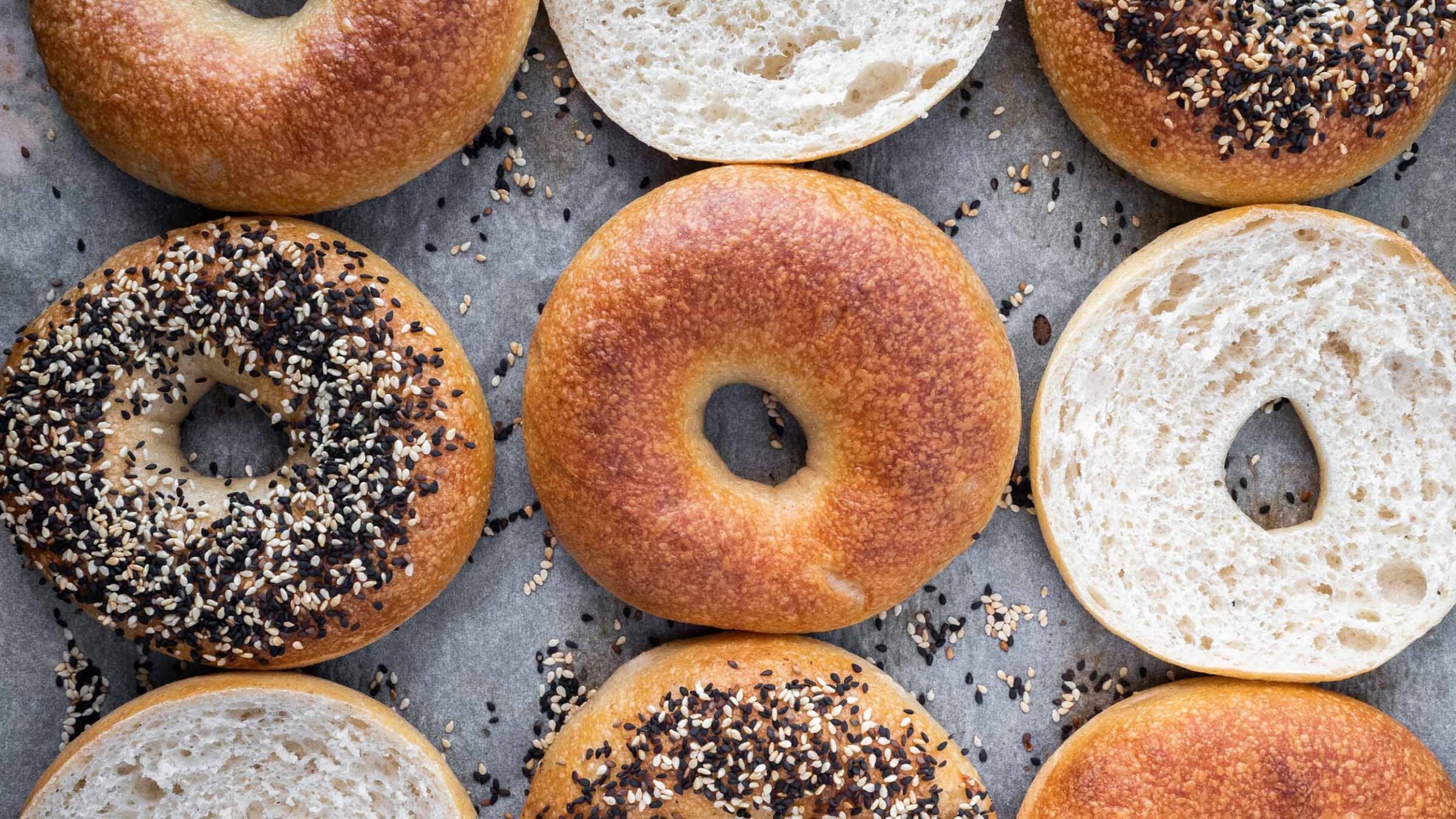 a variety of bagels on a tray