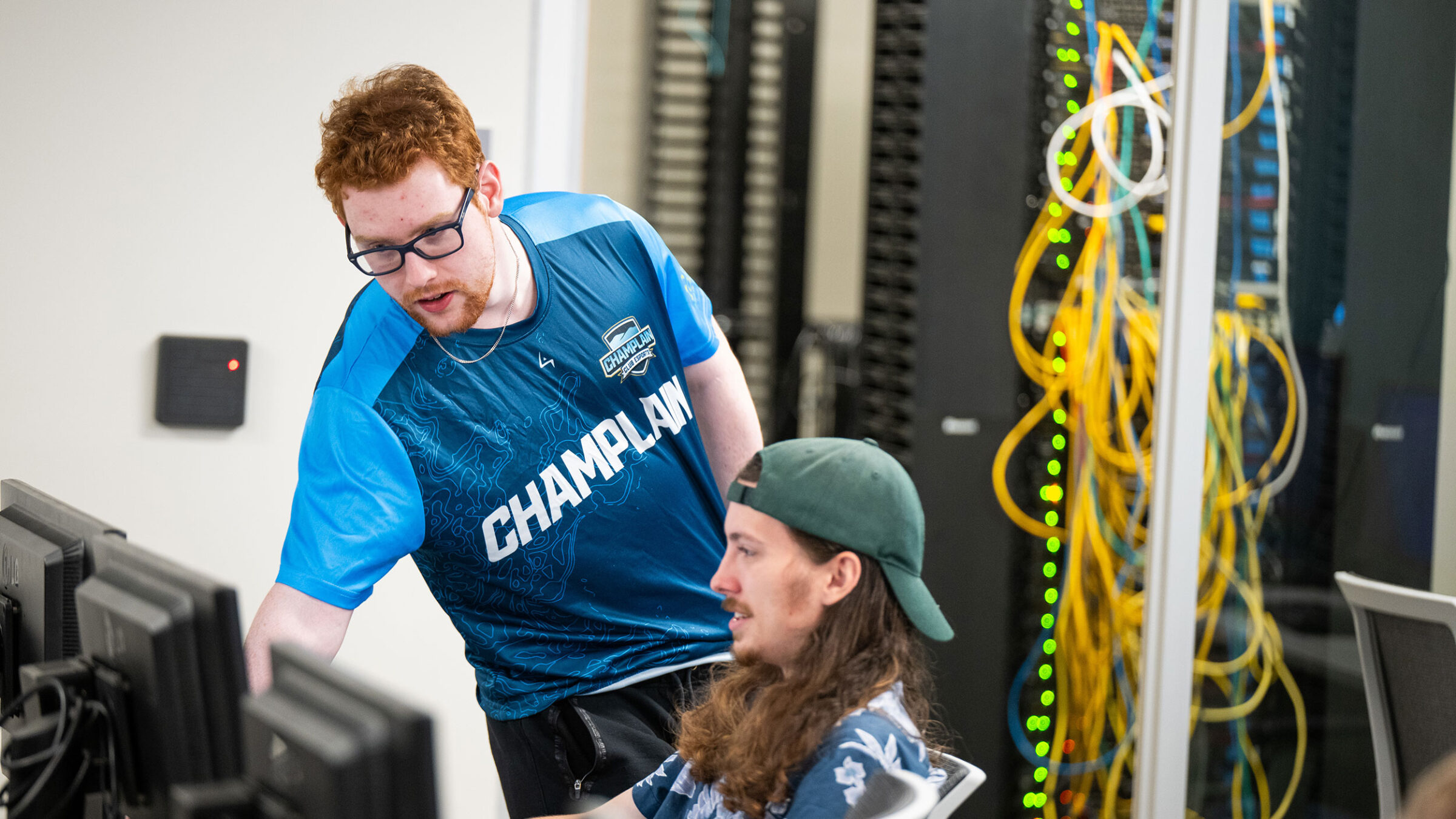 Two students work alongside each other at the Cyber Range at Champlain College.