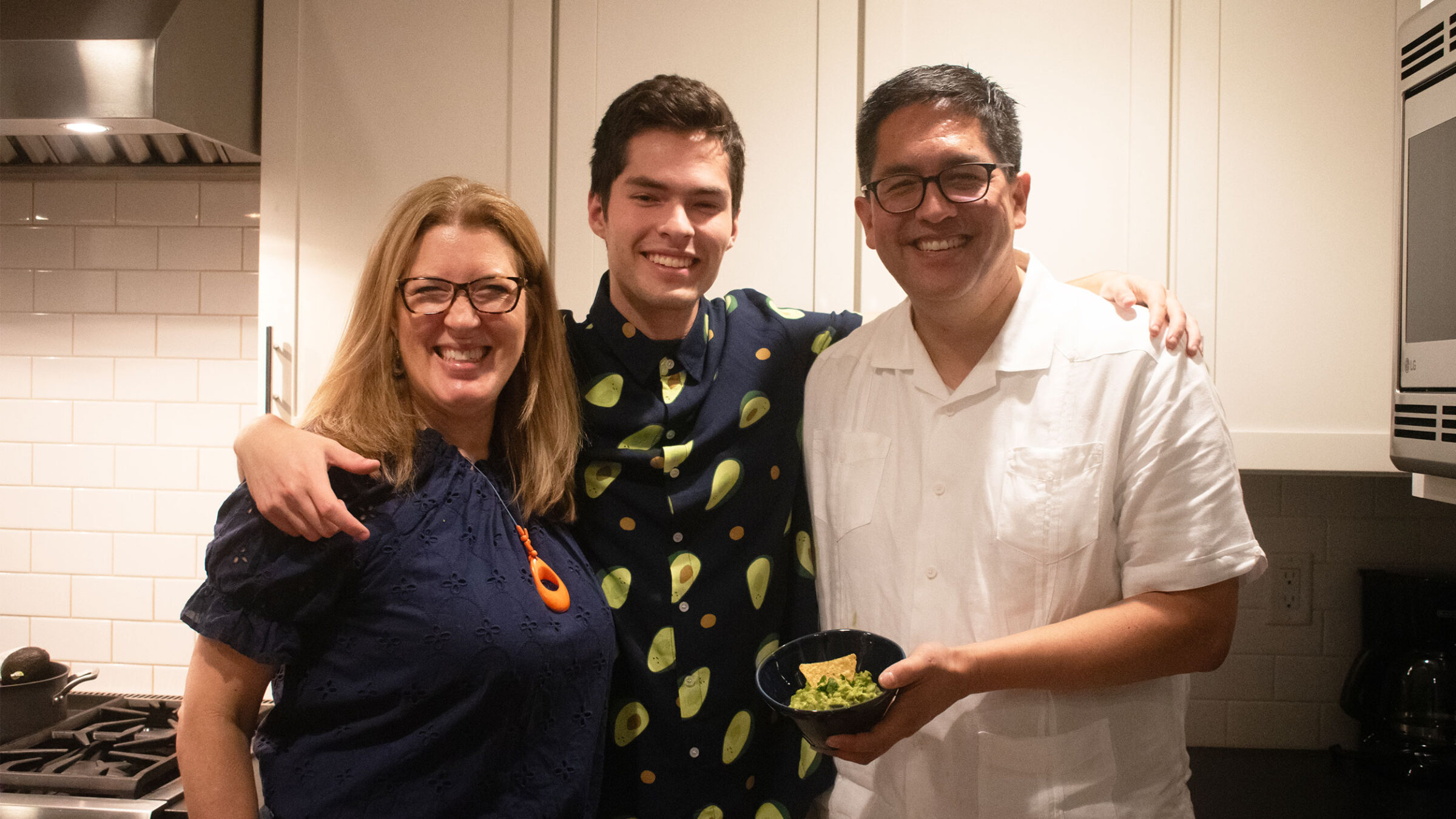 hernandez family smiling holding a bowl of homemade guac