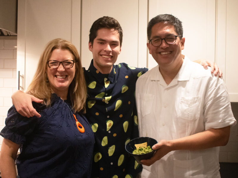 hernandez family smiling holding a bowl of homemade guac