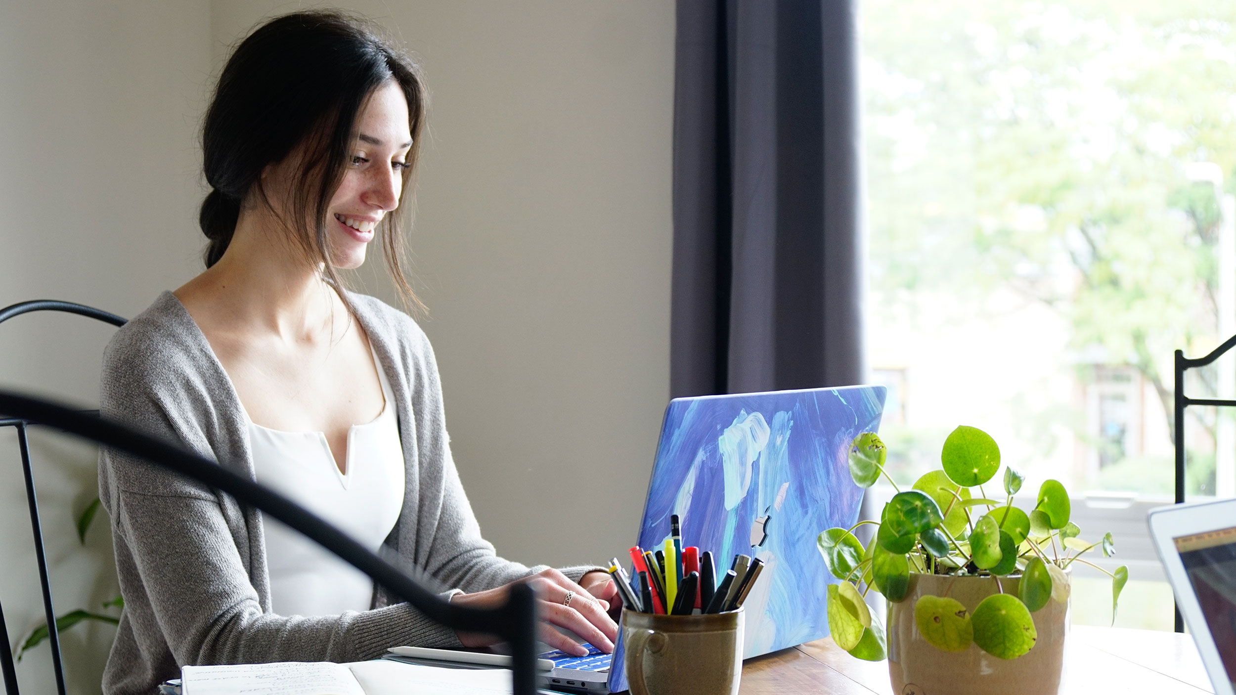 student works on laptop at the table