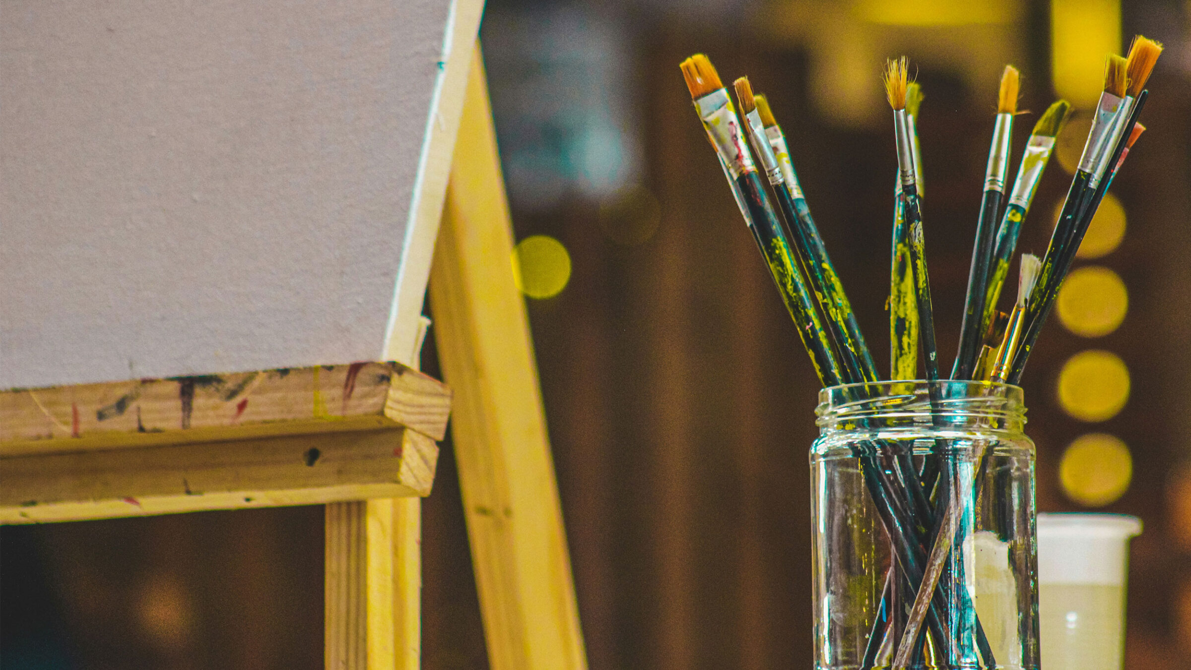 paint brushes in a mason jar