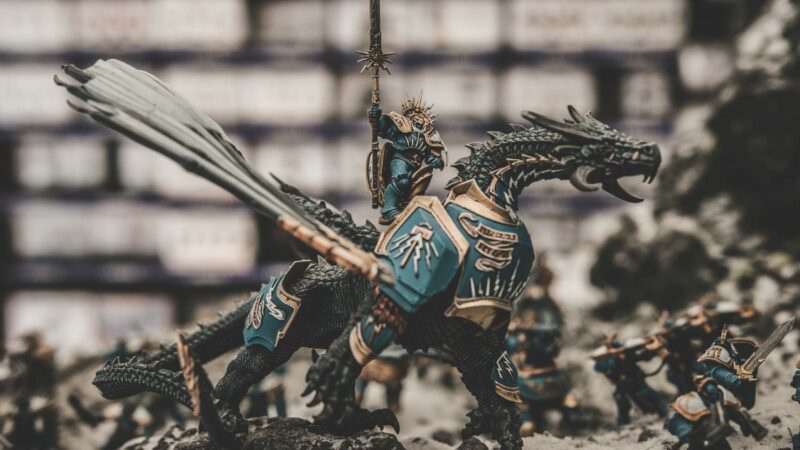 painted warhammer mini figures on a table posing for battle for a tabletop wargaming event