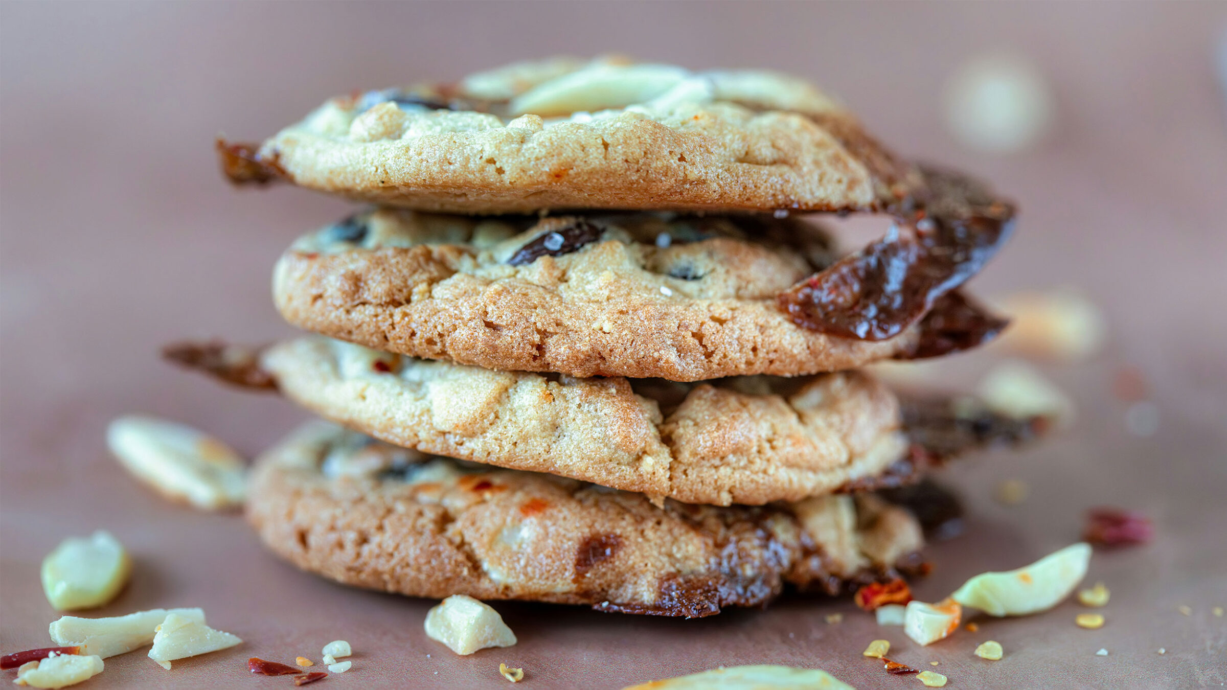 four chocolate chip cookies stacked on top of one another