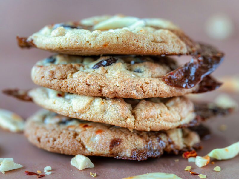 four chocolate chip cookies stacked on top of one another