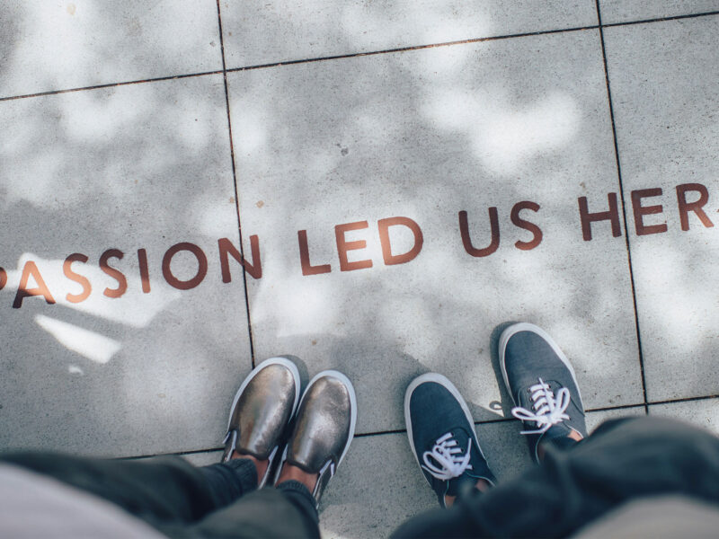 "passion led us here" painted on the sidewalk