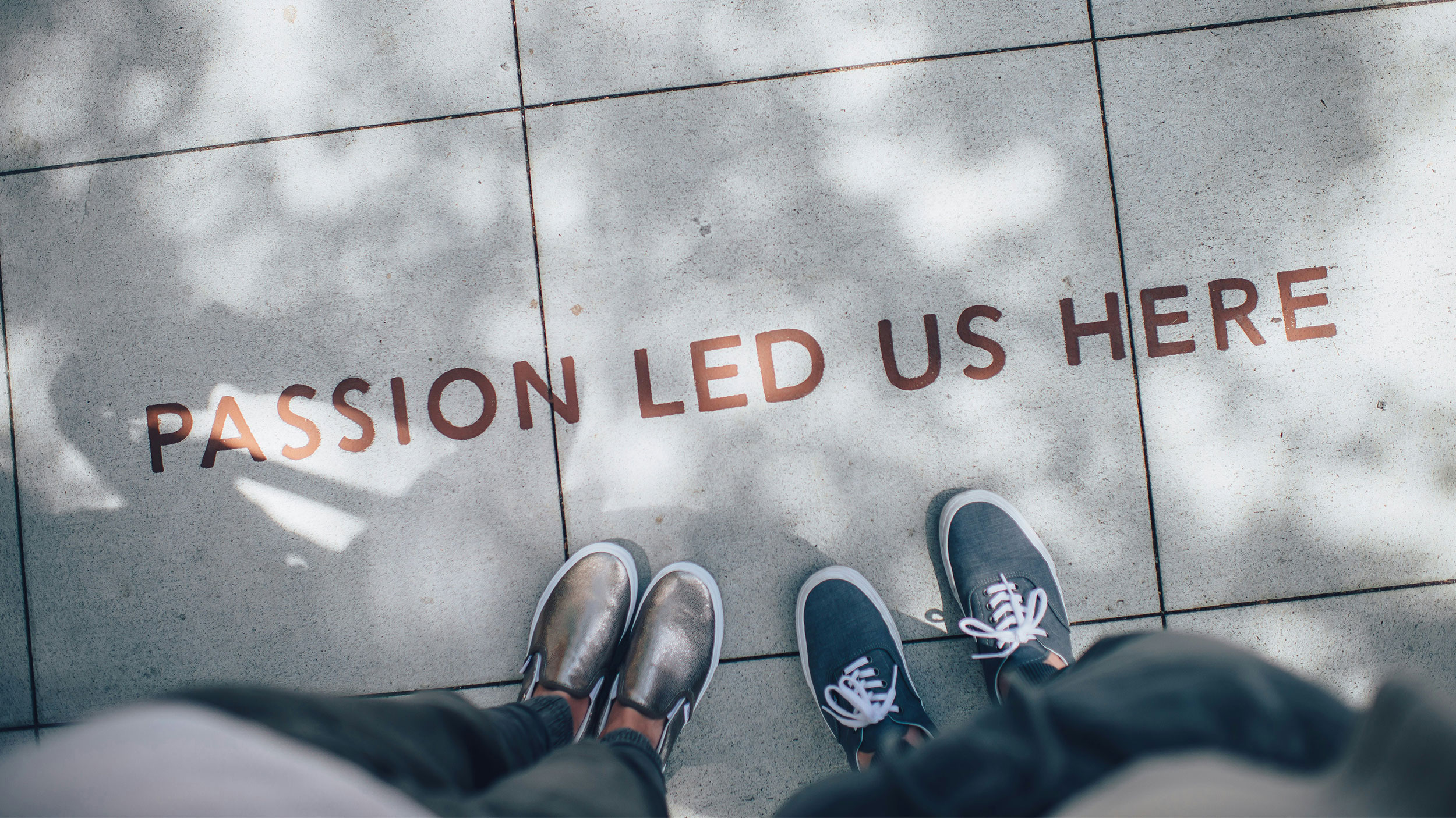 "passion led us here" painted on the sidewalk