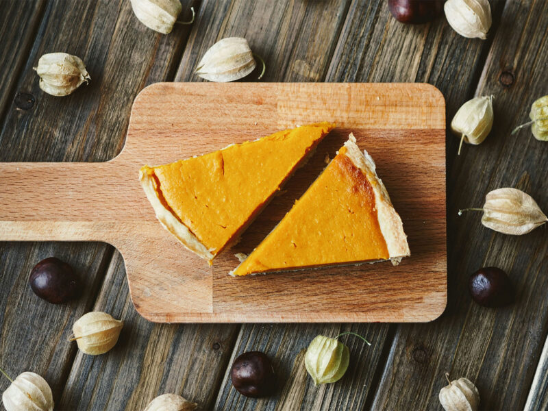 two slices of pumpkin pie on a cutting board