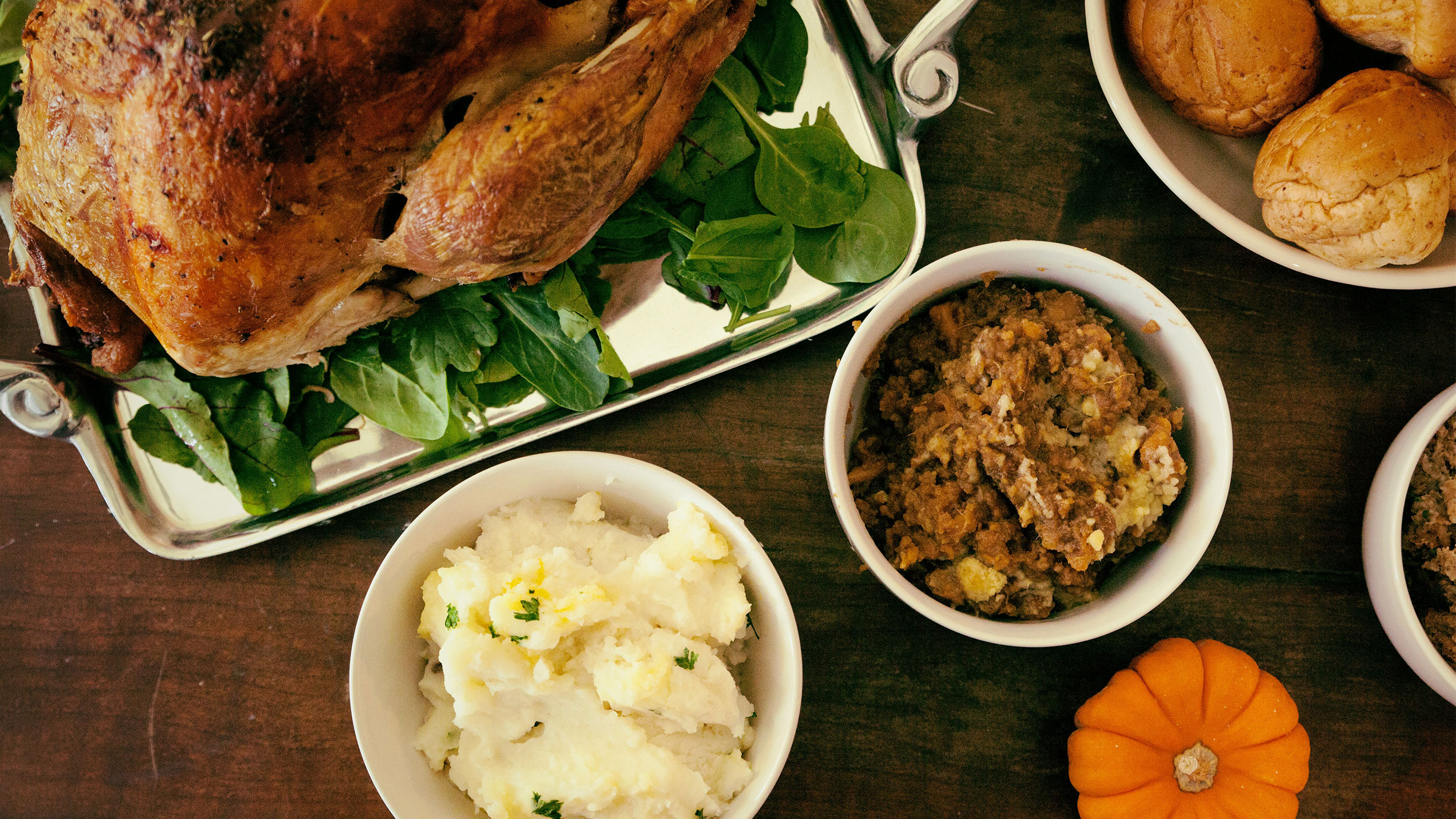 thanksgiving meal on the table with turkey, mashed potatoes, and stuffing