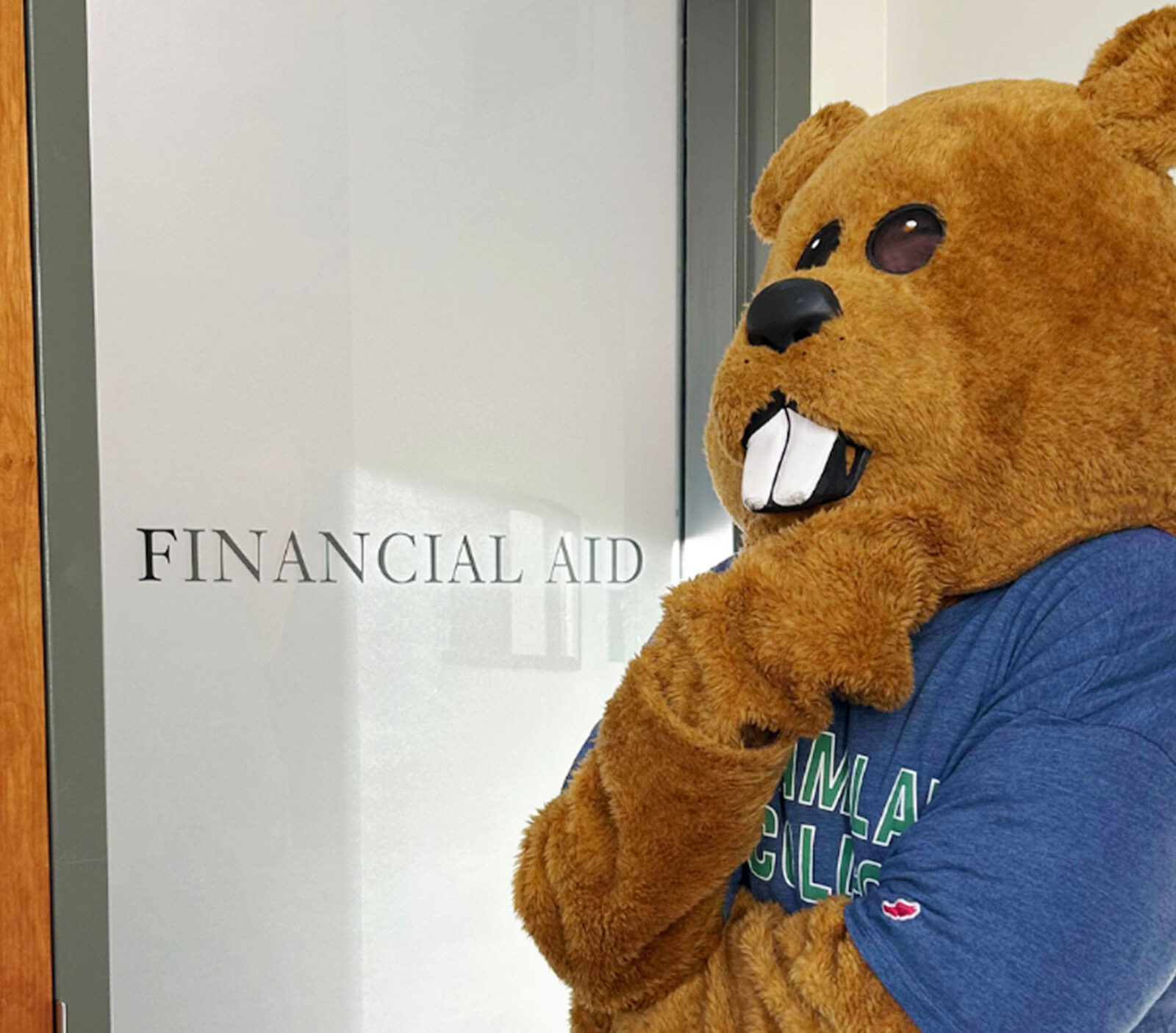 Chauncey standing in front of the office of financial aid