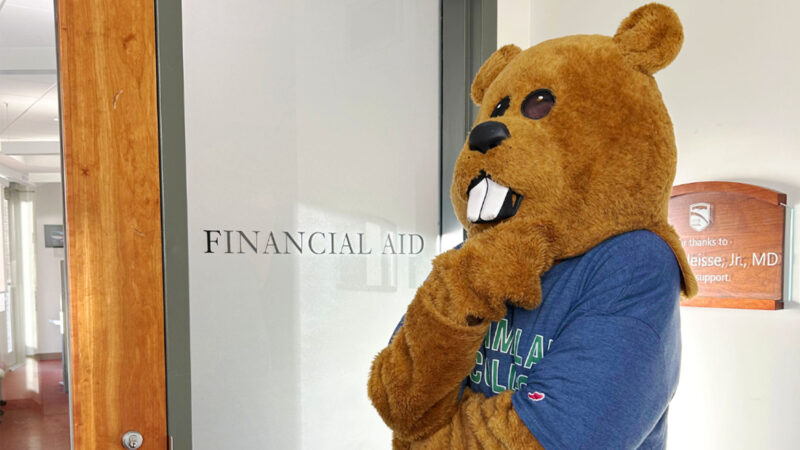 Chauncey standing in front of the office of financial aid