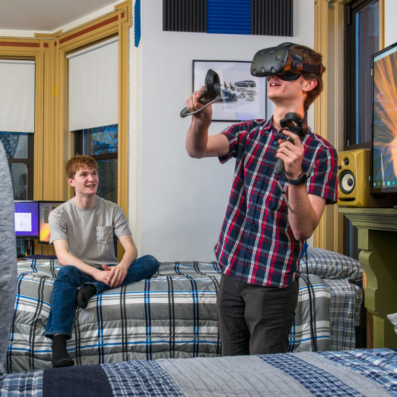 students using a VR headset in a dorm room