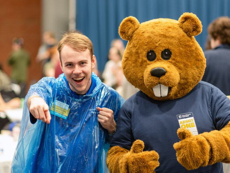 Chauncey the beaver and a student get hyped for the camera