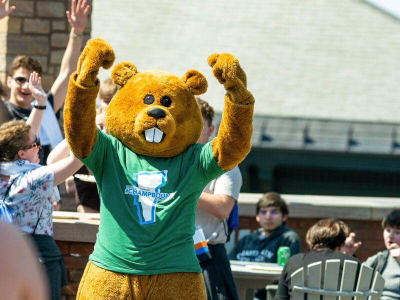 Chauncey the Beaver mascot throws arms in the air in success