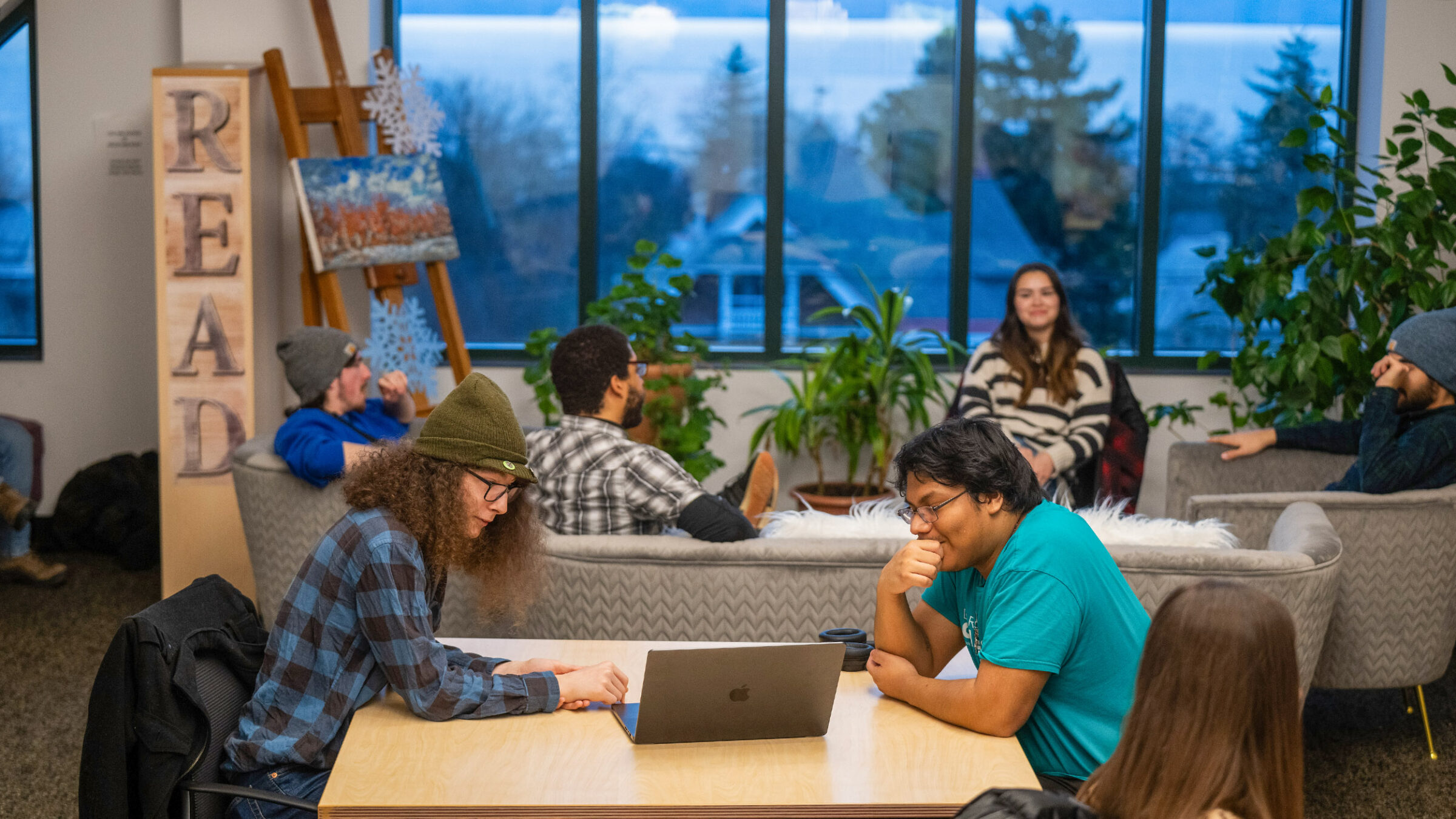 Students working in a communal classroom space