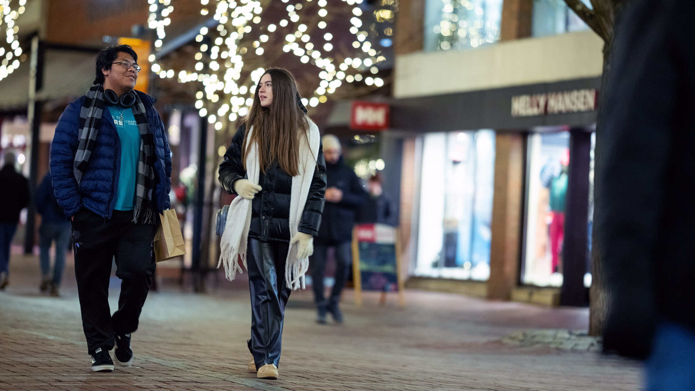 Students having a conversation while walking down Church Street in the winter.