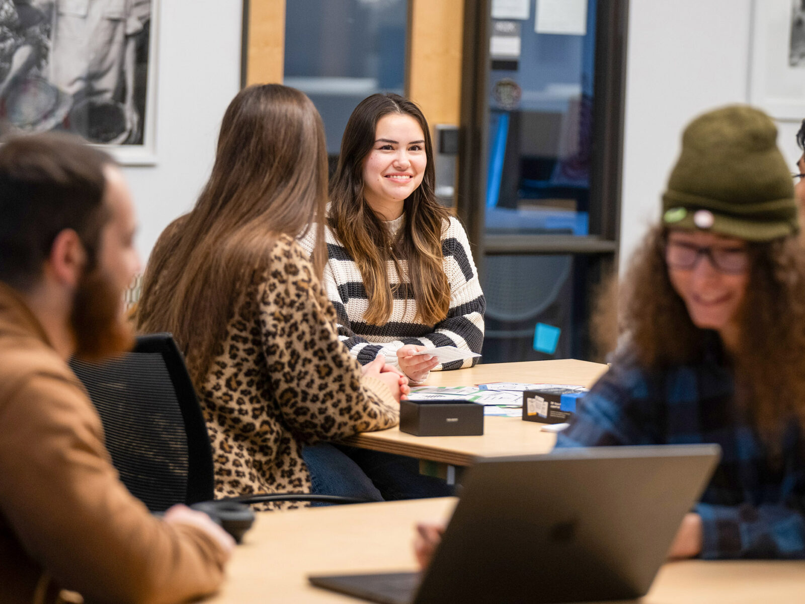 students gathered around a table talking