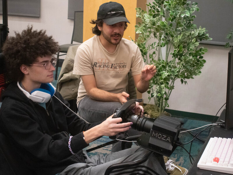 a student is simracing while another student watches