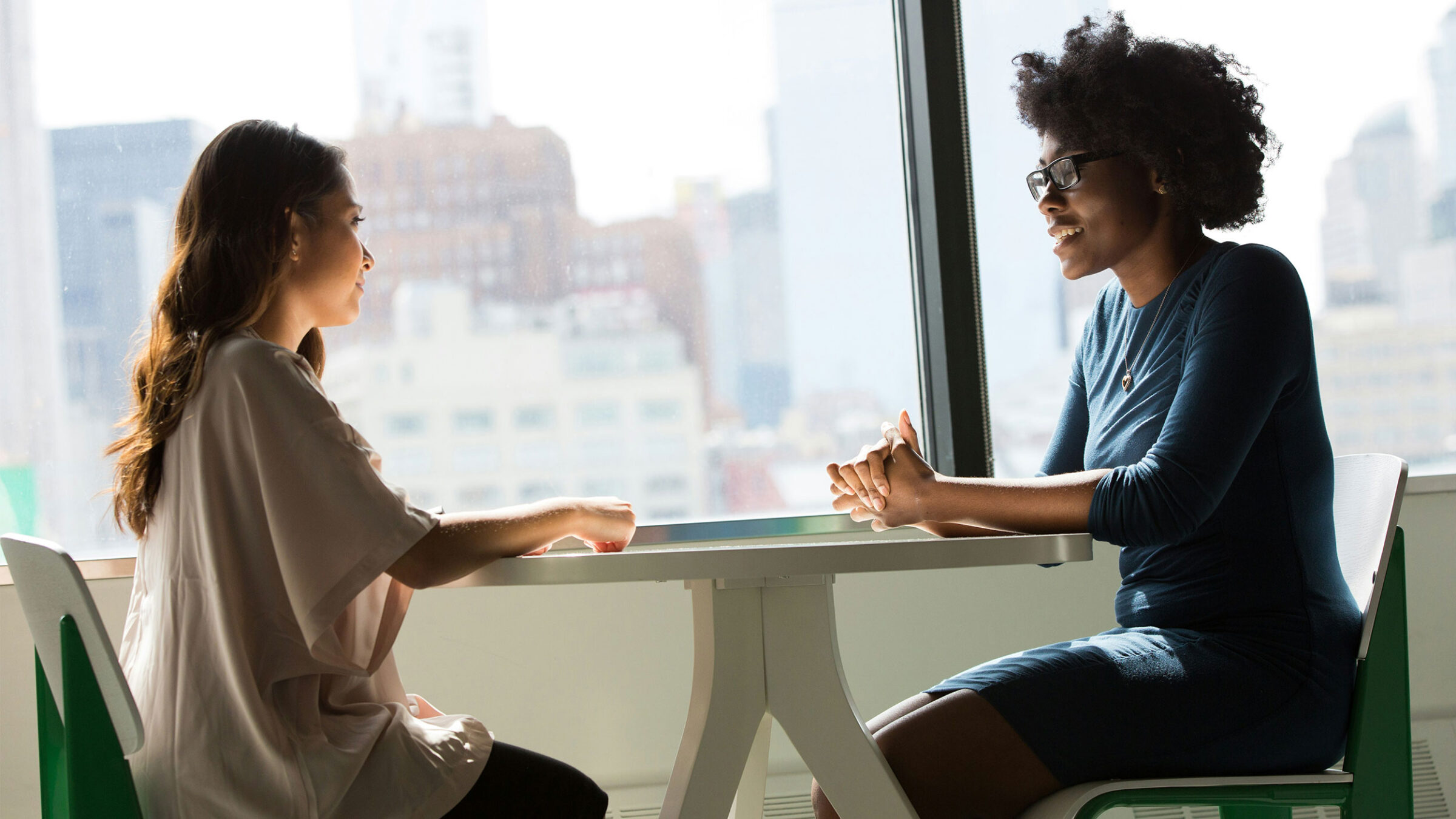 two people talking across a table