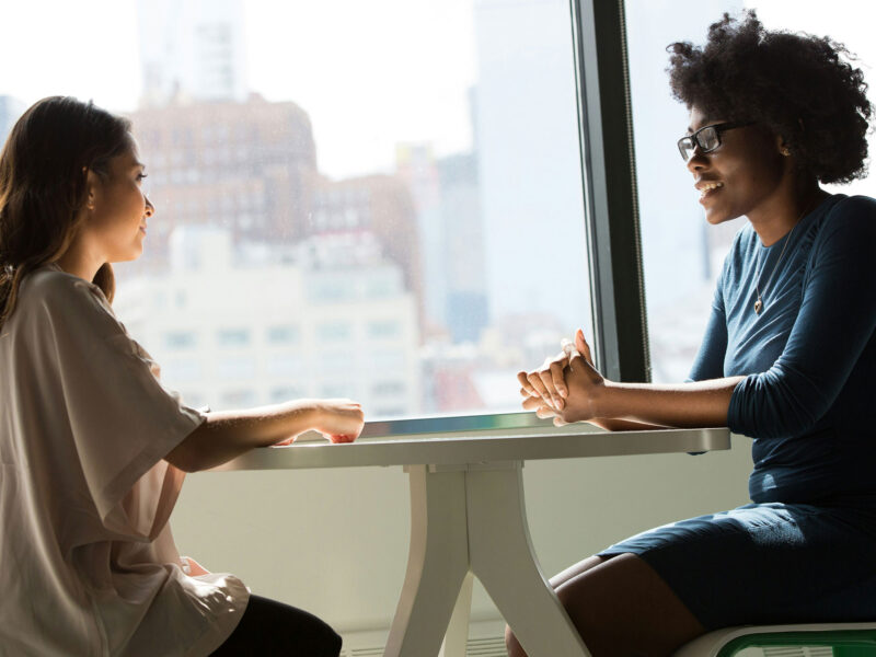 two people talking across a table